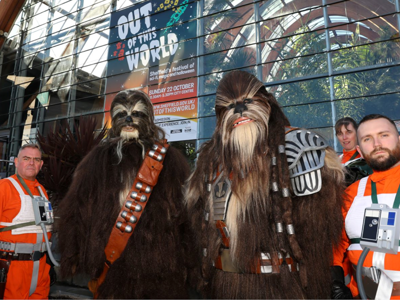 Performers dressed as wookies and Rebel pilots from the Star Wars films, outside the Sheffield Winter Garden.