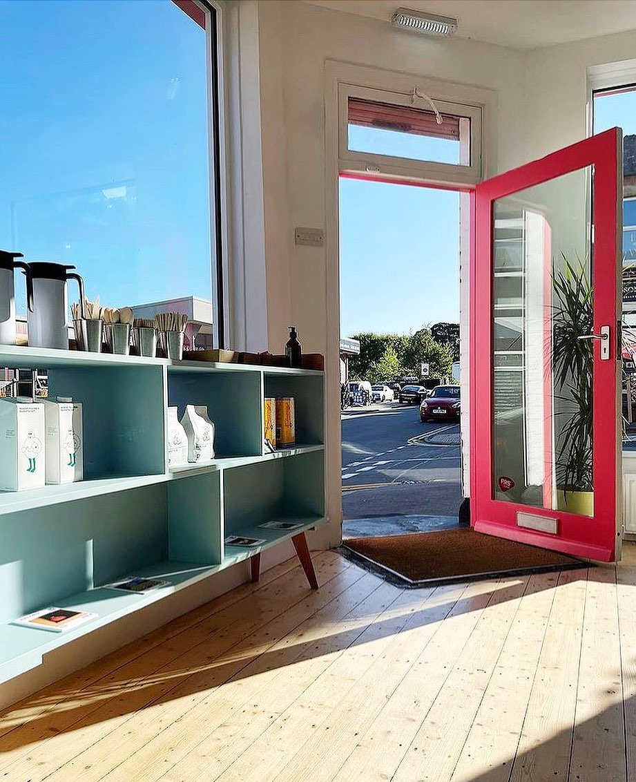 The entrance to the Corner Store through their bright red door.