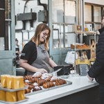 A customer at the counter, being served, at The Depot Bakery.