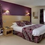Deluxe bedroom at Best Western Plus Mosborough Hall Hotel with king-size bed and modern furnishings.