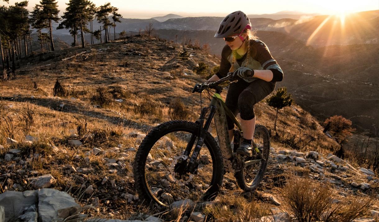 A woman peddling up a steep slope at Fox Valley on a mountain bike.
