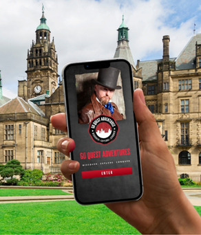 A smartphone being held up in front of Sheffield Town Hall and the Peace gardens, with a tour App on the screen.