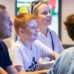 A family having fun, playing games, at the National Videogame Museum.