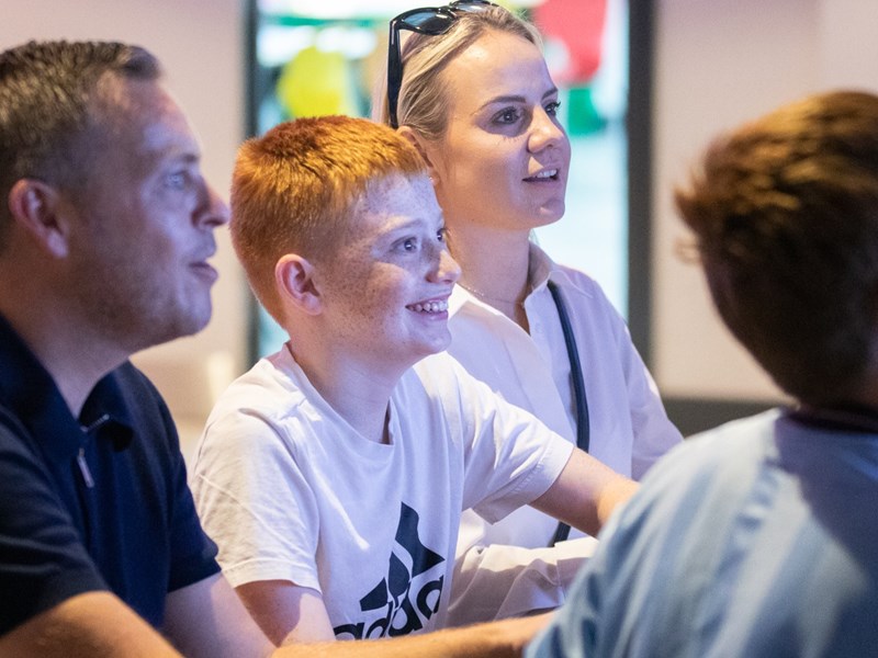 A family having fun, playing games, at the National Videogame Museum.