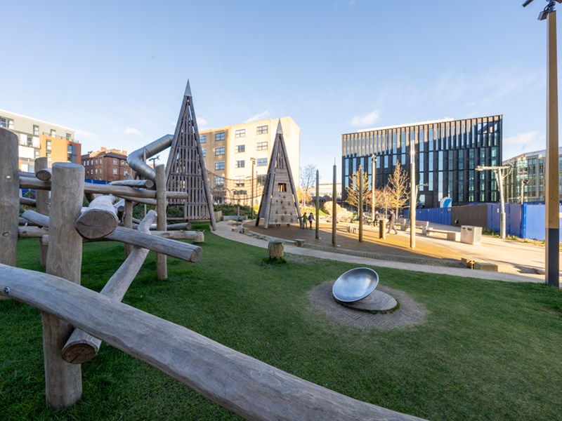 A view across Pound's Park, showing the play equipment and beches.