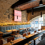 The interior of Tavern On The Quays with its bare stone walls and vaulted ceiling.