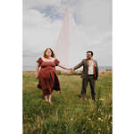 Will Finn and Rosie Calvert standing in a field in front of an obelisk.
