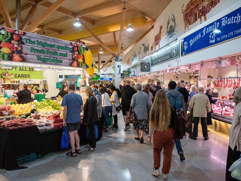 Stalls at The Moor Market surrounded by shoppers.