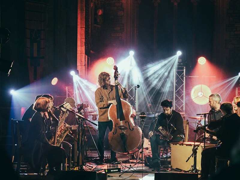 A band performing in a darkened church.