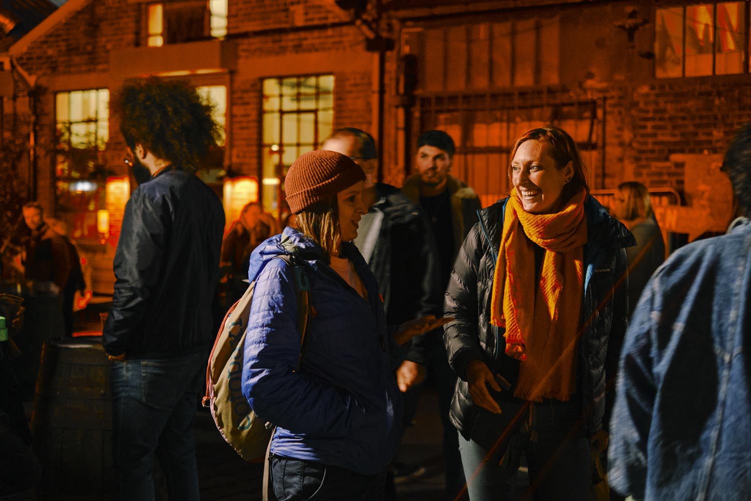 A small group of people are laughing and chatting at Peddlars Market.
