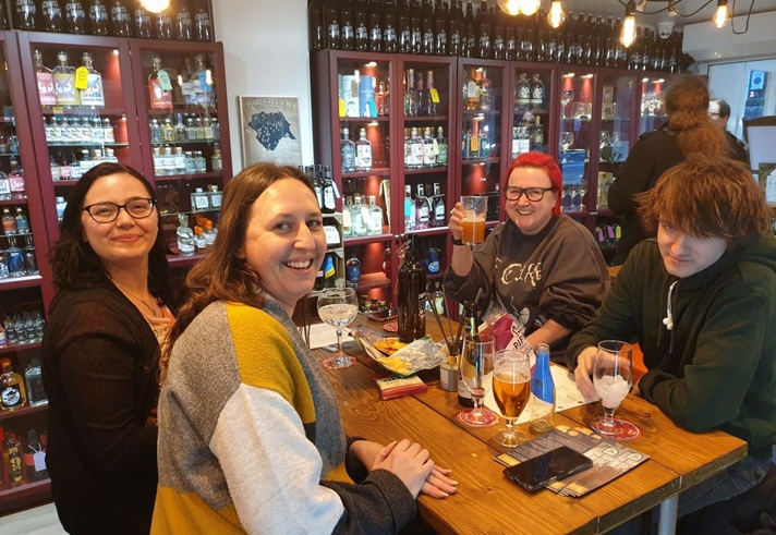 Four people enjoying a night out at Craft & Berry.