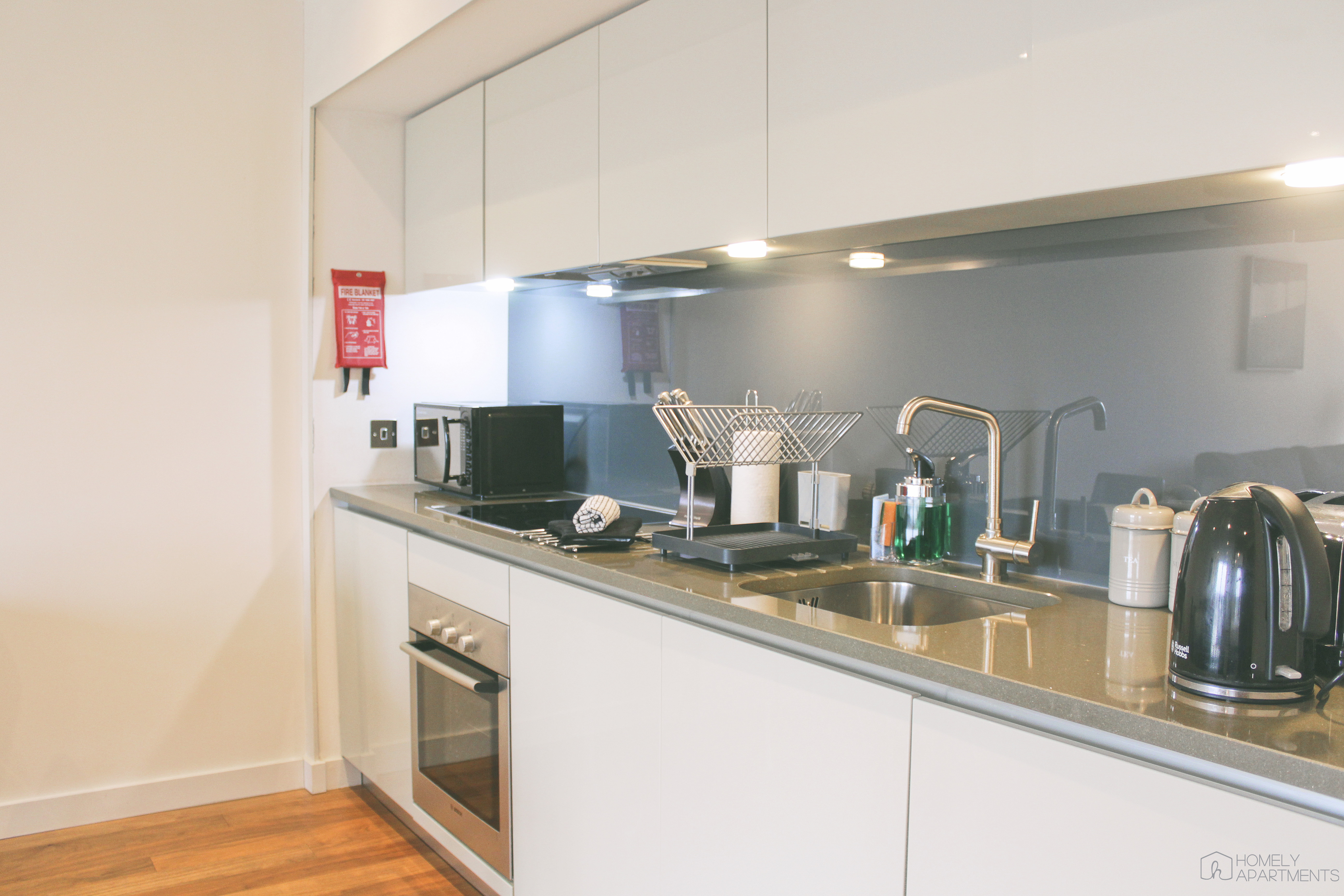 Modern kitchen at Homely Serviced Apartments – St. Paul’s with appliances and storage units.
