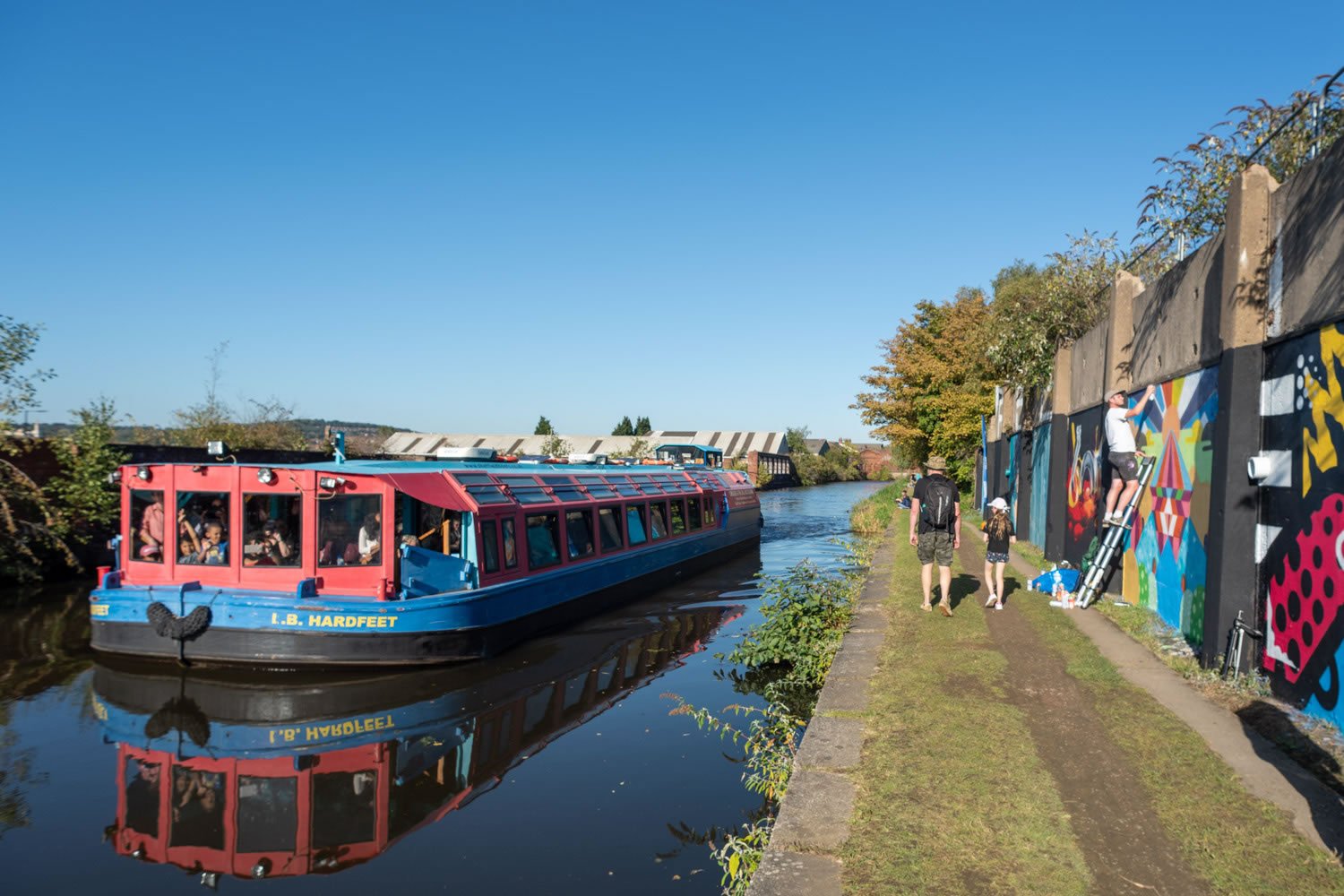 A canal boat motoring along a canal.