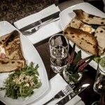 An overhead shot of a table with plates of food at Inox Dine.