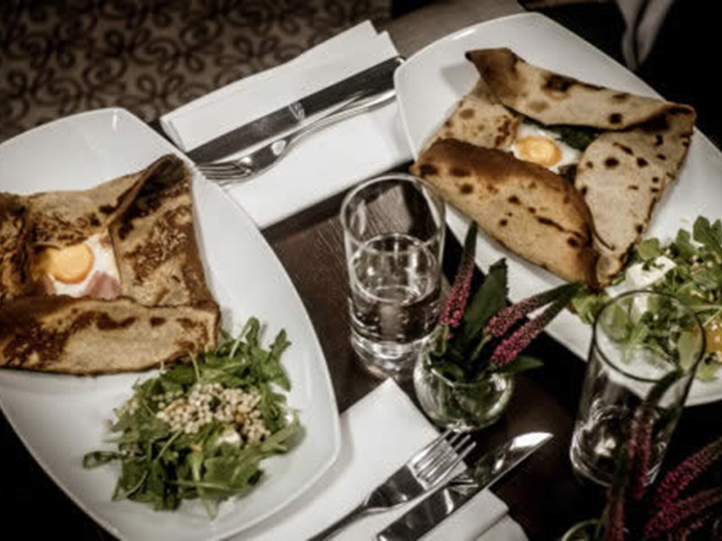 An overhead shot of a table with plates of food at Inox Dine.