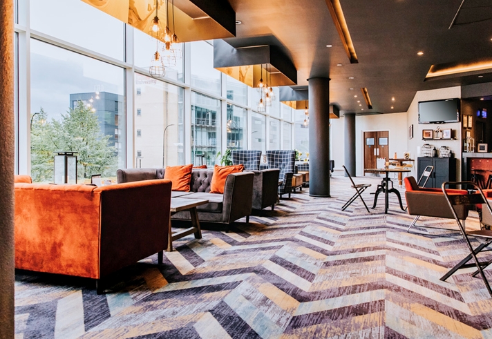 Contemporary bar area with large, comfortable seats and modern decor.