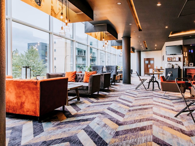 Contemporary bar area with large, comfortable seats and modern decor.