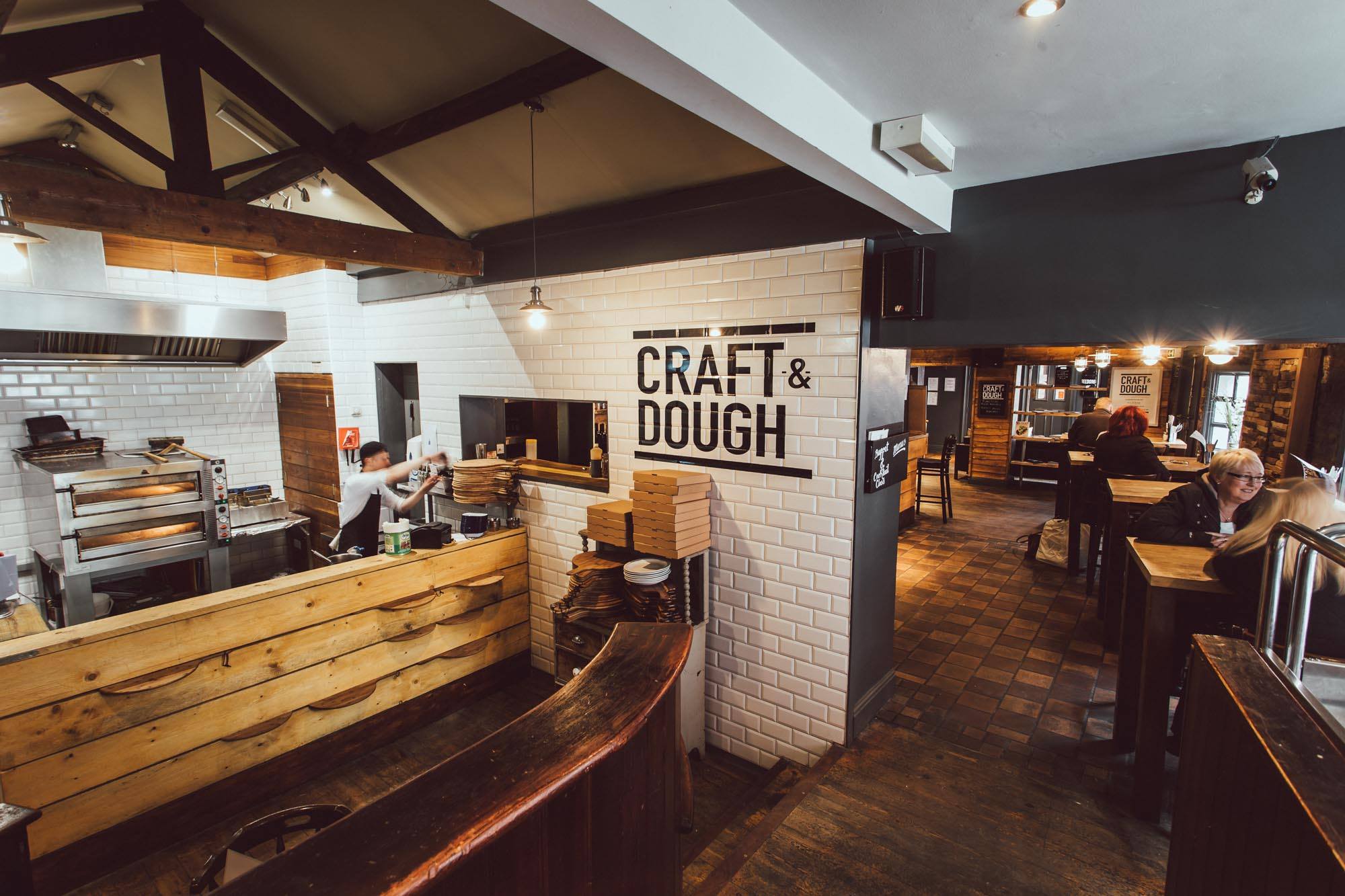 The interior of Craft And Doug with a view of the kitchen and the seating area.