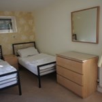 A twin room featuring two single beds and simple, cozy decor.