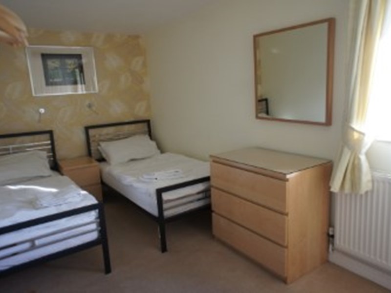 A twin room featuring two single beds and simple, cozy decor.