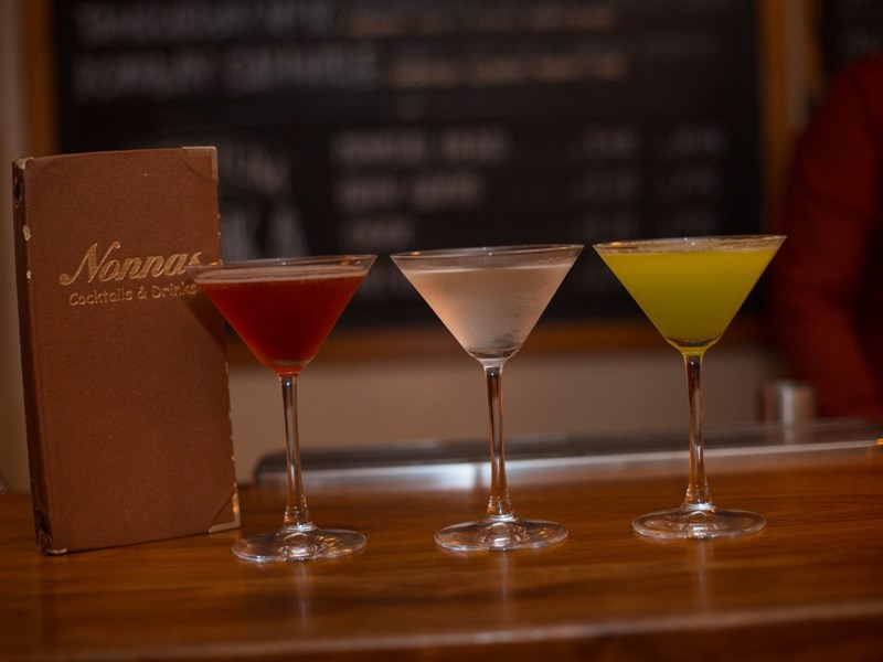 Three cocktails on a bar at Nonnas Restaurant.