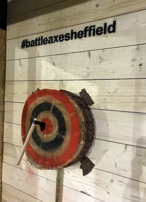 An axe in the bullseye on a target at Battle Axe Sheffield.