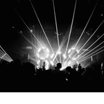 A black and white photograph of a crowd dancing in a nightclub.