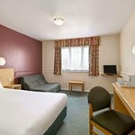 Bedroom featuring a double bed positioned near a window with natural light.