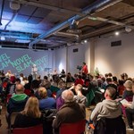 A seated audience listening to a speaker at an Off The Shelf event.