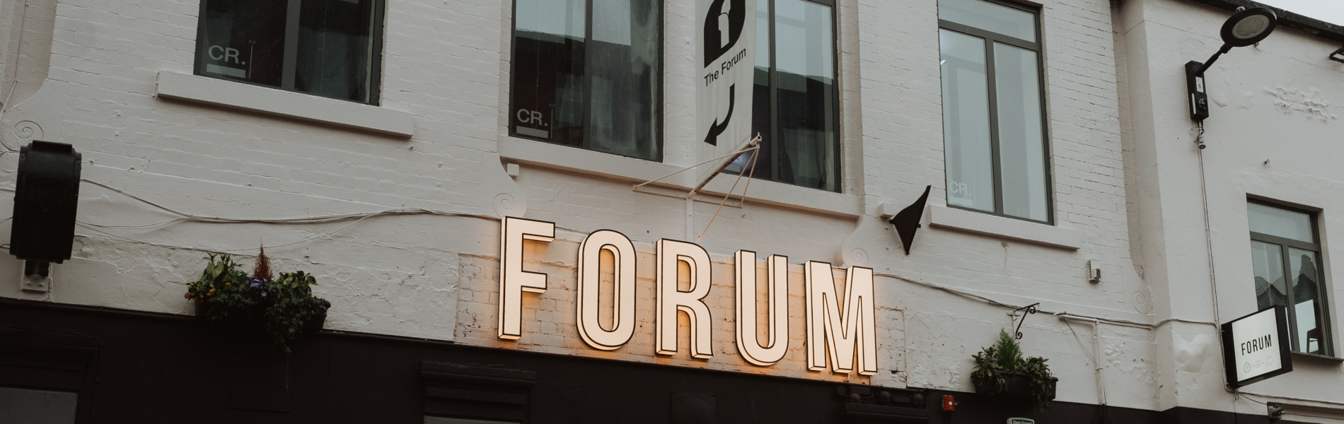 Forum Kitchen + Bar sign on the outside of the building.