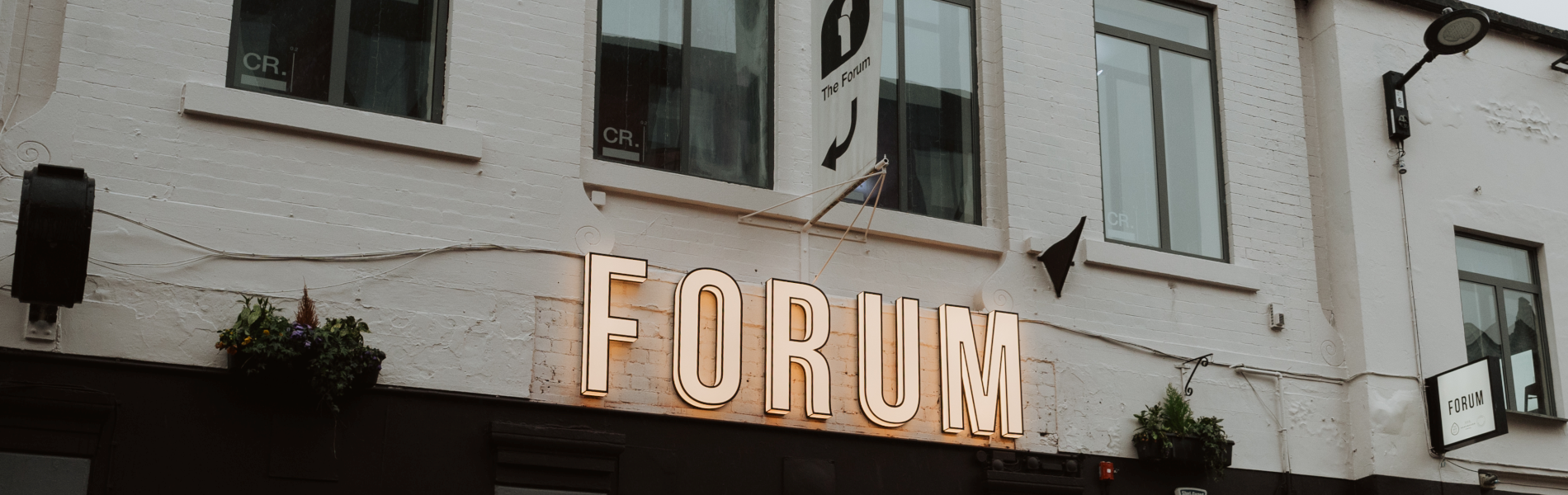 Forum Kitchen + Bar sign on the outside of the building.