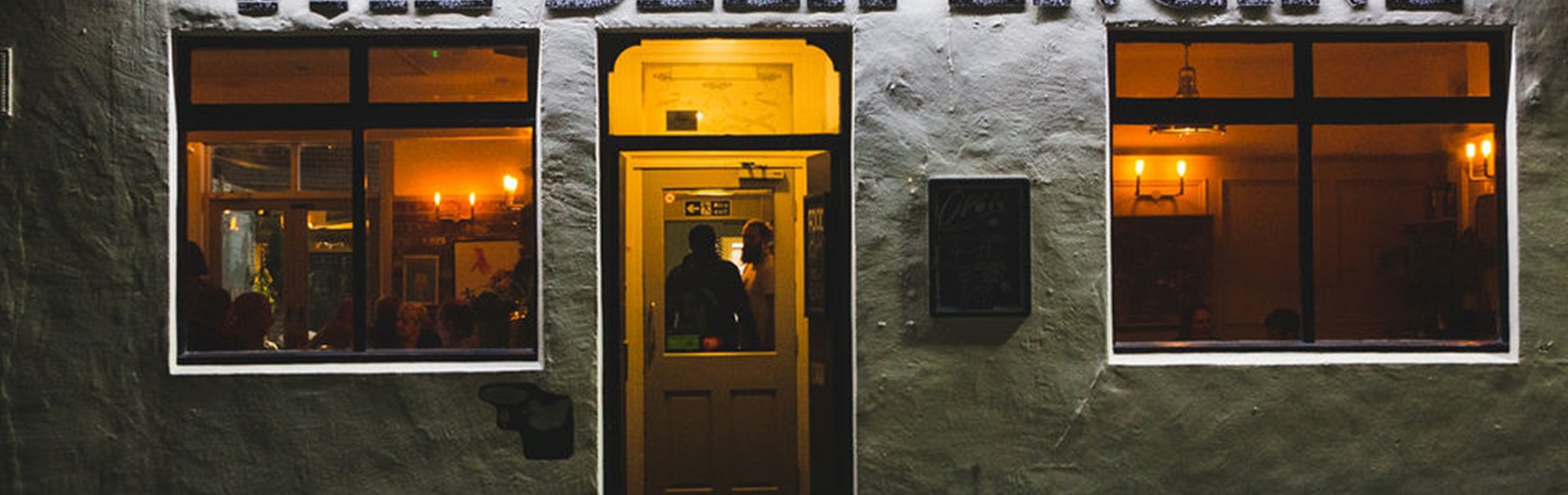 Exterior shot of The Beer Engine, lit up at night.