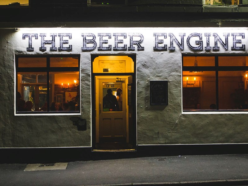 Exterior shot of The Beer Engine, lit up at night.