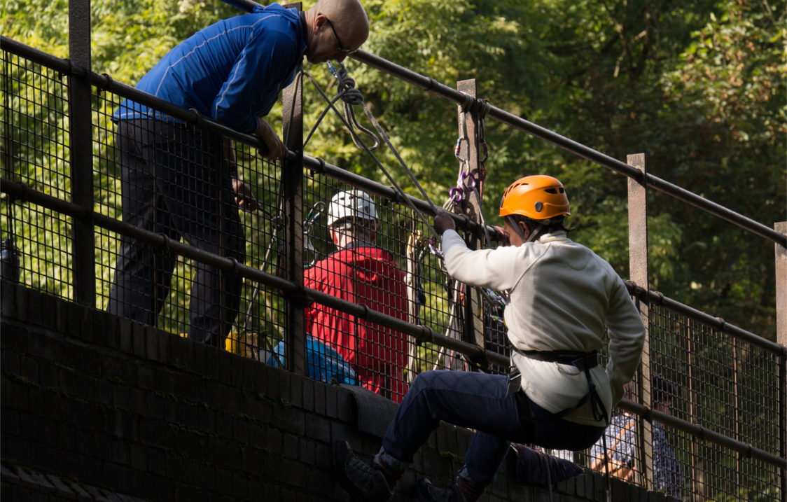 People abseiling off a bridge.