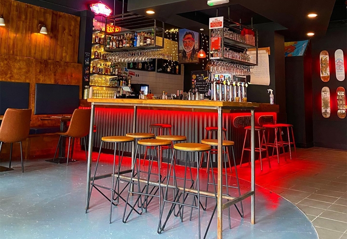 The bar at Cheap Dates, lit up with red lighting.