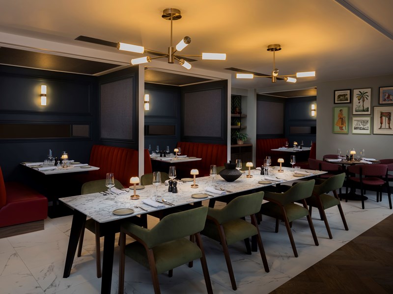 Restaurant with a set long table and chairs, with booths positioned behind.