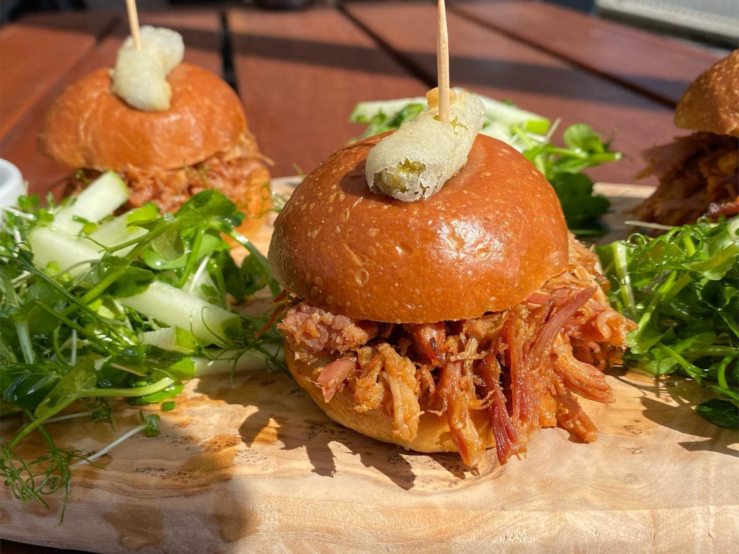 Burgers and salad being served at Over The Yardarm