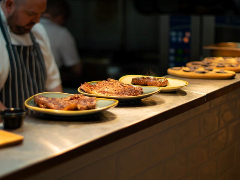 Rows of dishes on a counter top waiting to be served.