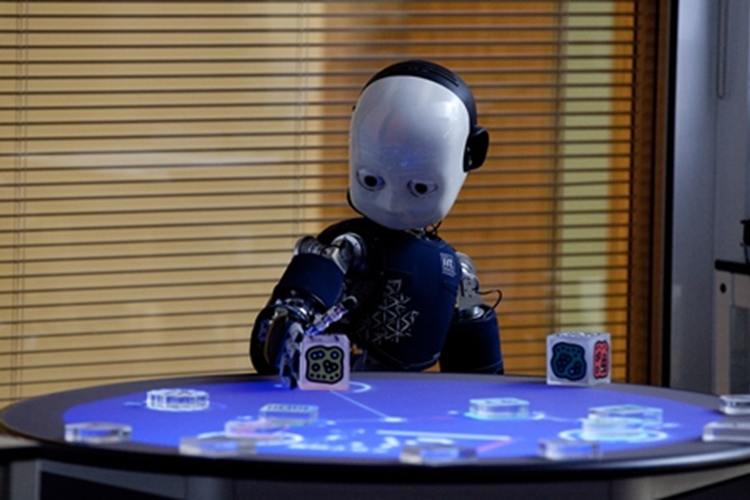 A blue humanoid robot with a white face developed by Sheffield Robotics.