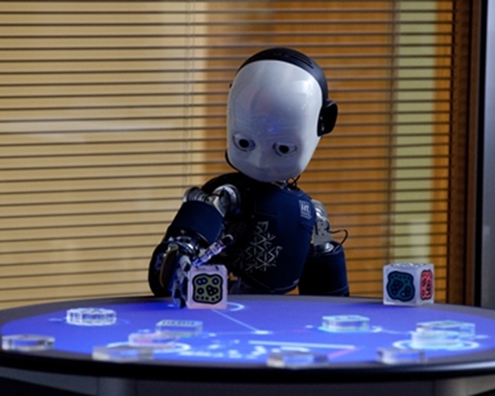 A blue humanoid robot with a white face developed by Sheffield Robotics.