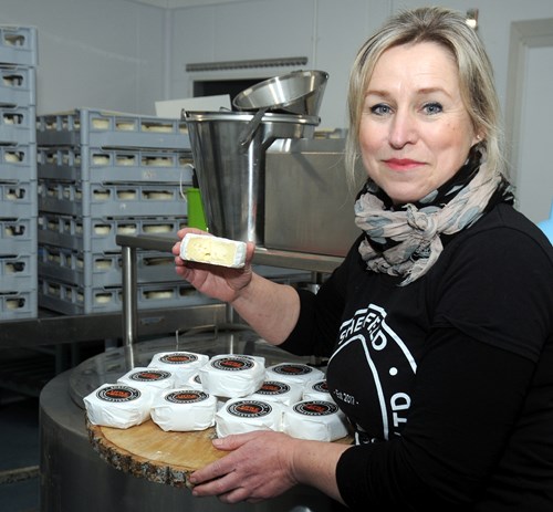 Sophie Williams, founder of Sheffield Cheesemaster, poses with some cheese.