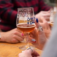 People enjoying a beer outdoors at The Brewery of St Mars of the Desert.