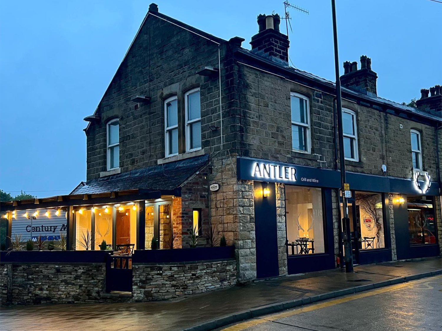 Exterior of The Antler at night.