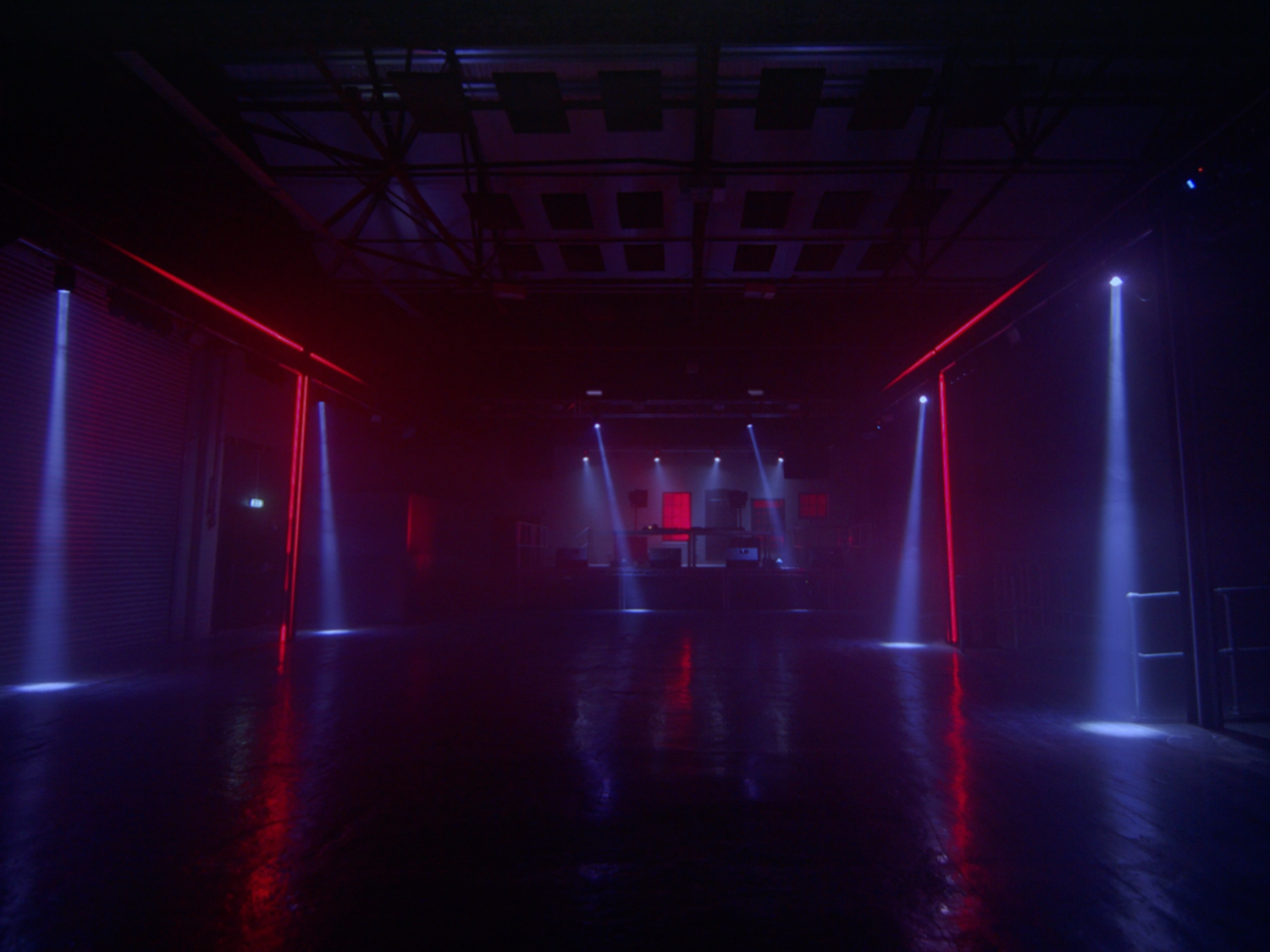 The interior of FØRGE with red neon lights glowing in the darkness.