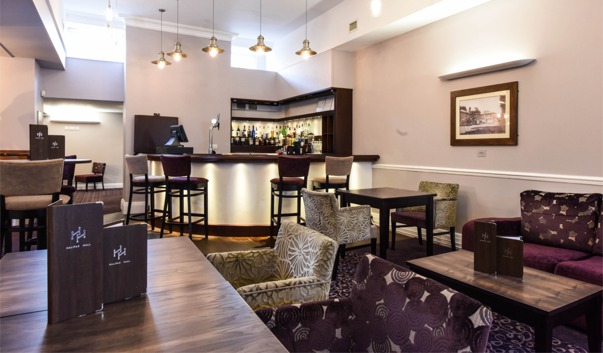 Contemporary hotel restaurant with natural light, modern décor, and neatly arranged tables.