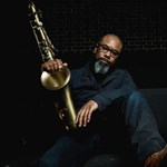 Denys Baptiste posing with his saxaphone.