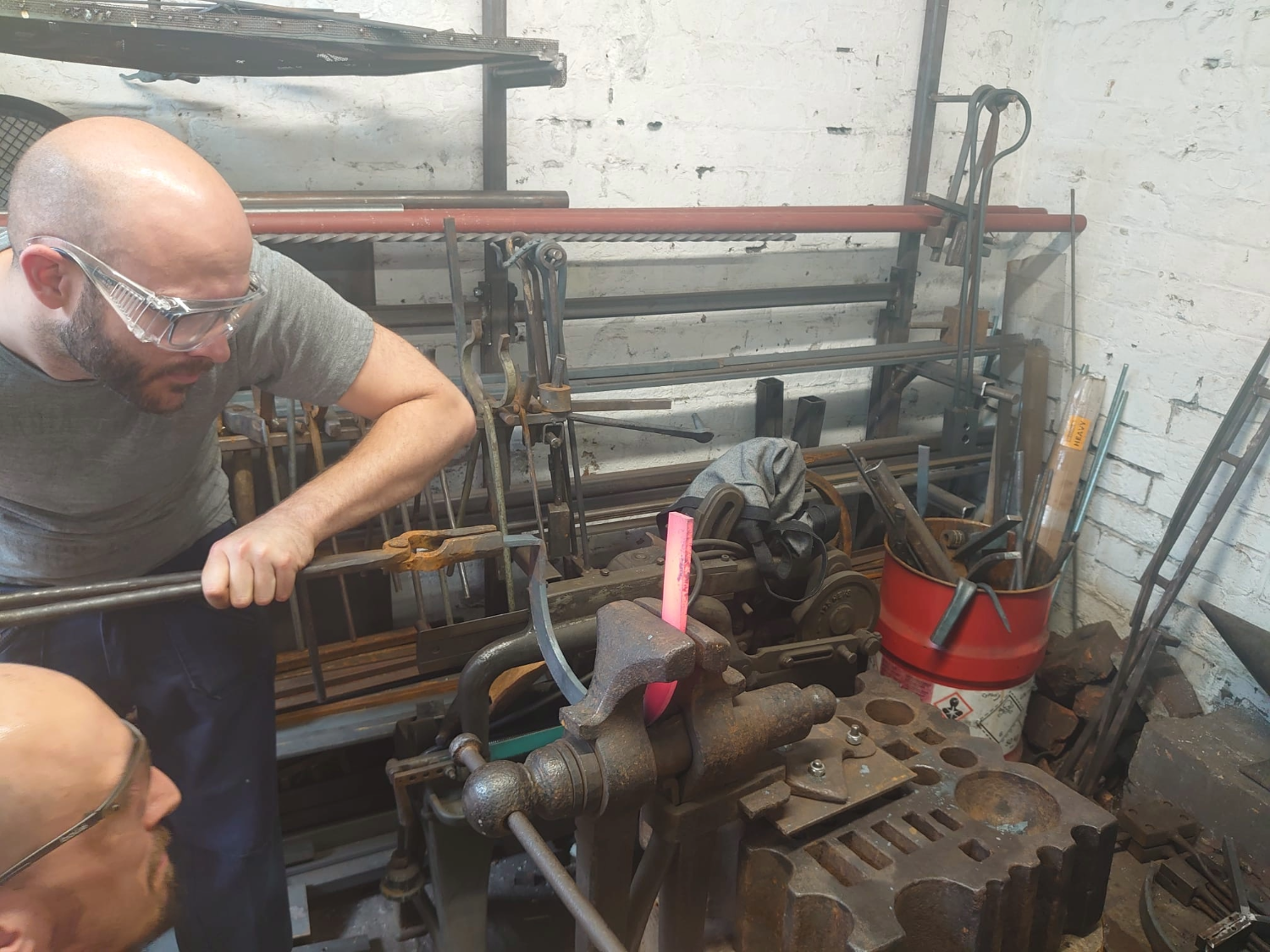 Two men hard at work in a forge.