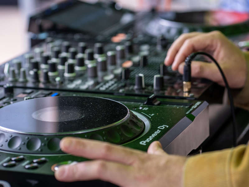 A DJ playing music on decks.