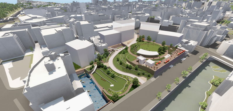 Digital rendering of an urban redevelopment project showing a landscaped green space surrounded by white building blocks. The design includes curved pathways, grassy areas, trees, and seating zones, with a central open space featuring a large canopy structure. On the right, there is a canal bordered by trees, and on the left, a blue climbing wall area. The surrounding city buildings are shown in simplified white models under bright daylight.