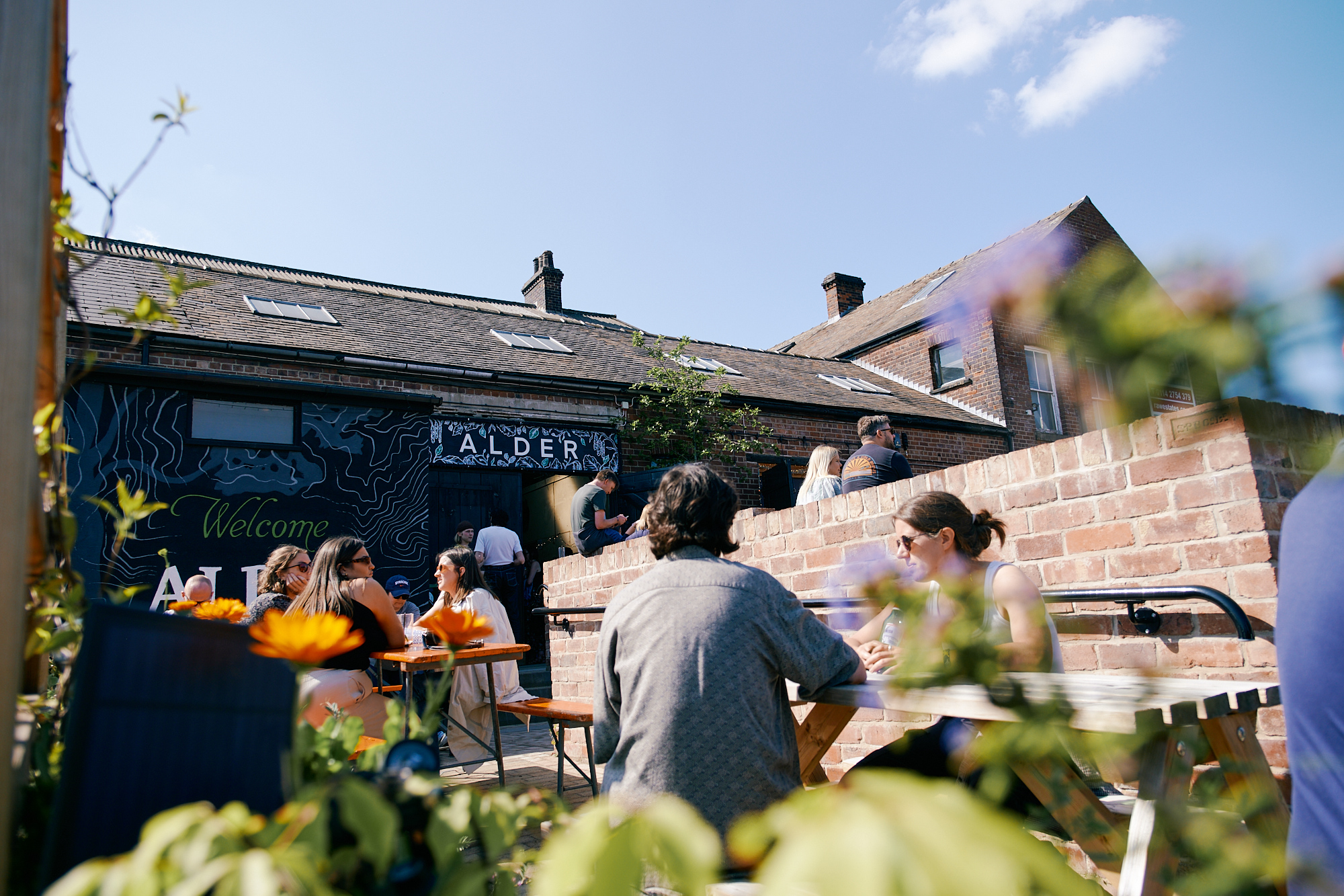 People enjoying the sunny exterior of Alder Sheffield in Kelham Island 
